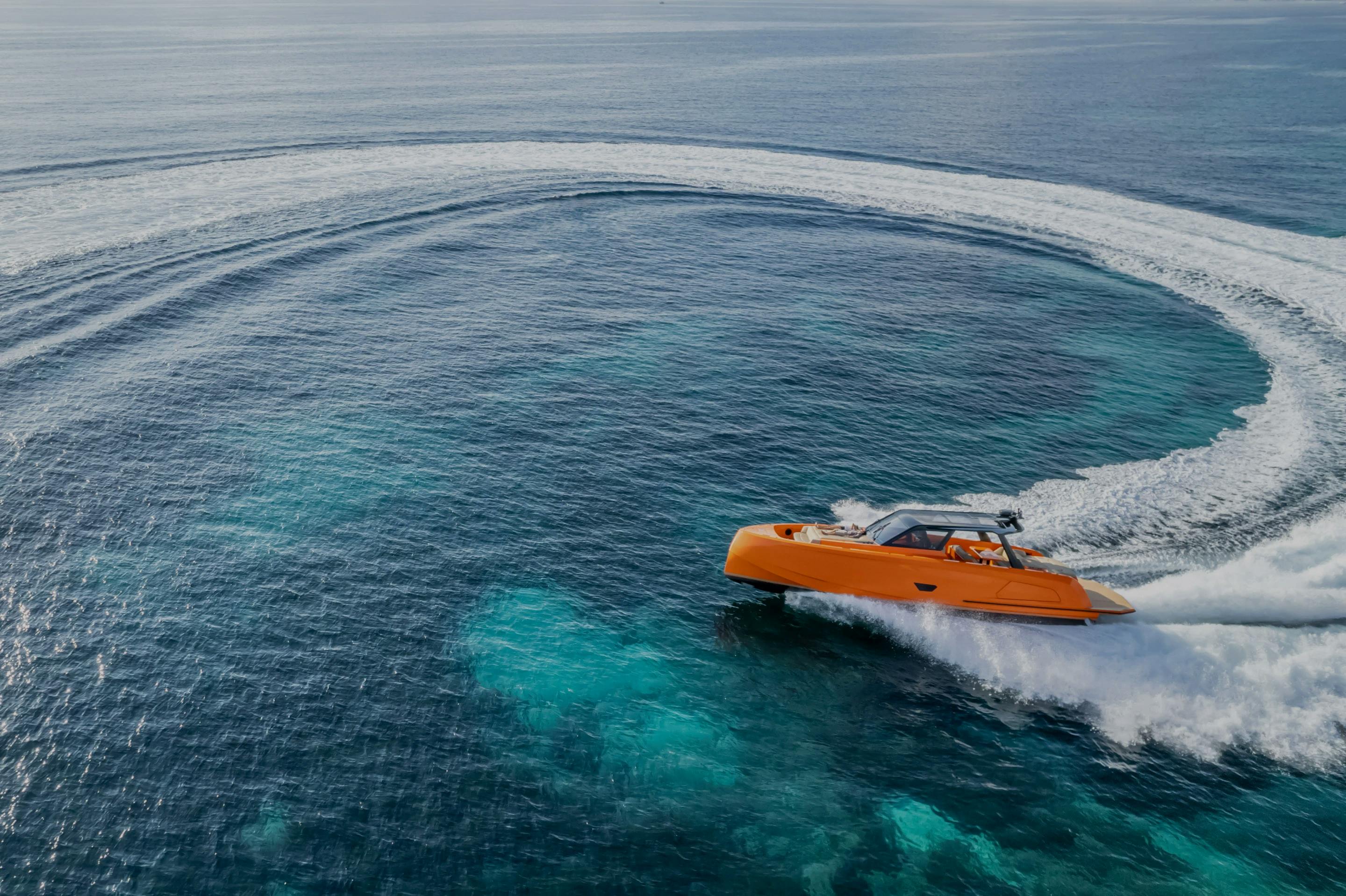 Vanquish Yacht Orange Yacht making donuts in the sea