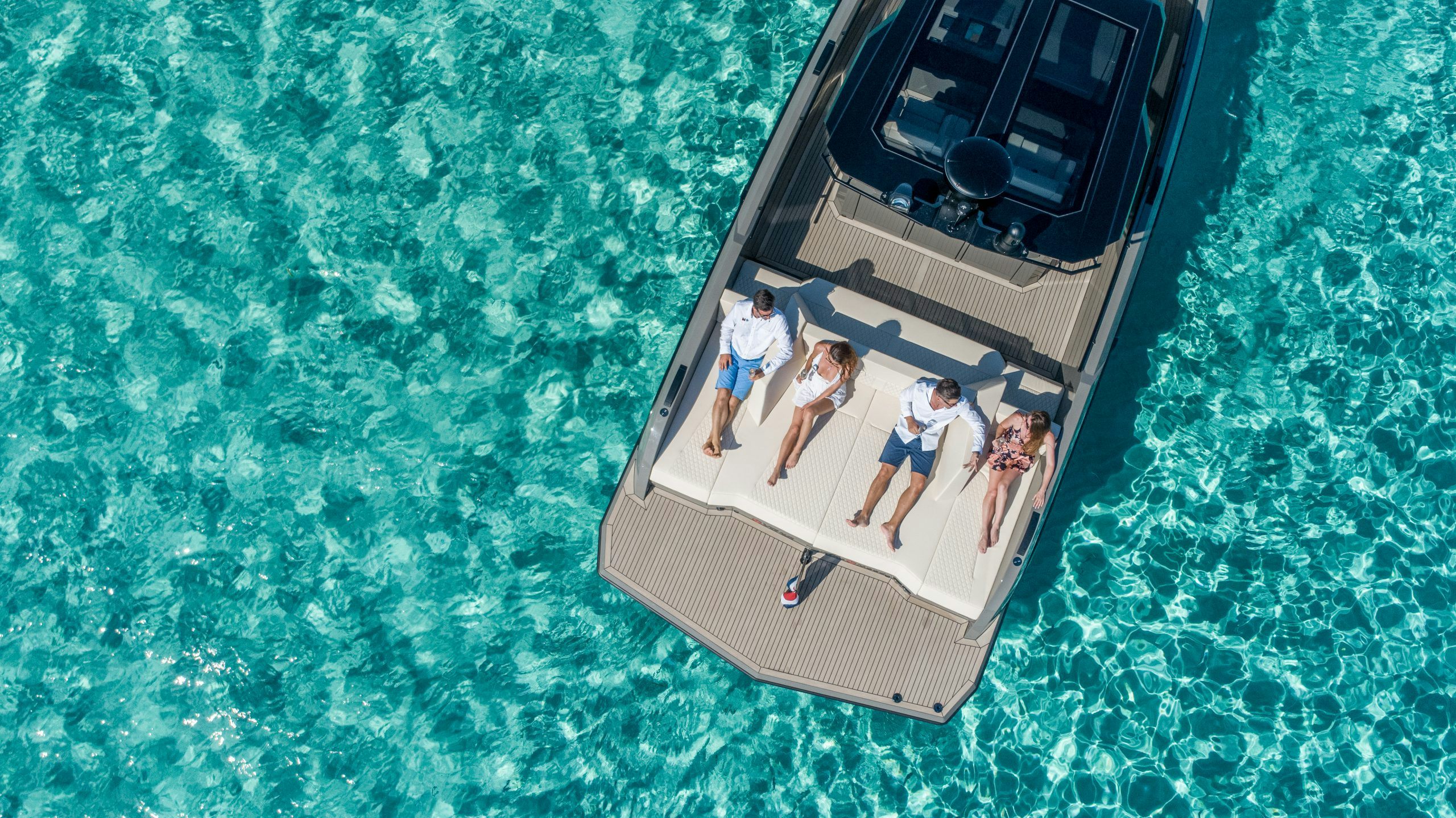 vanquish exterior aerial view people relaxing on the yacht