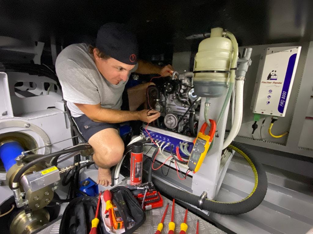 vanquish employee working on mechanics of a yacht